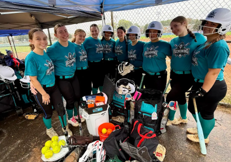 Reckoning Softball players gathered with their gear in the dugout